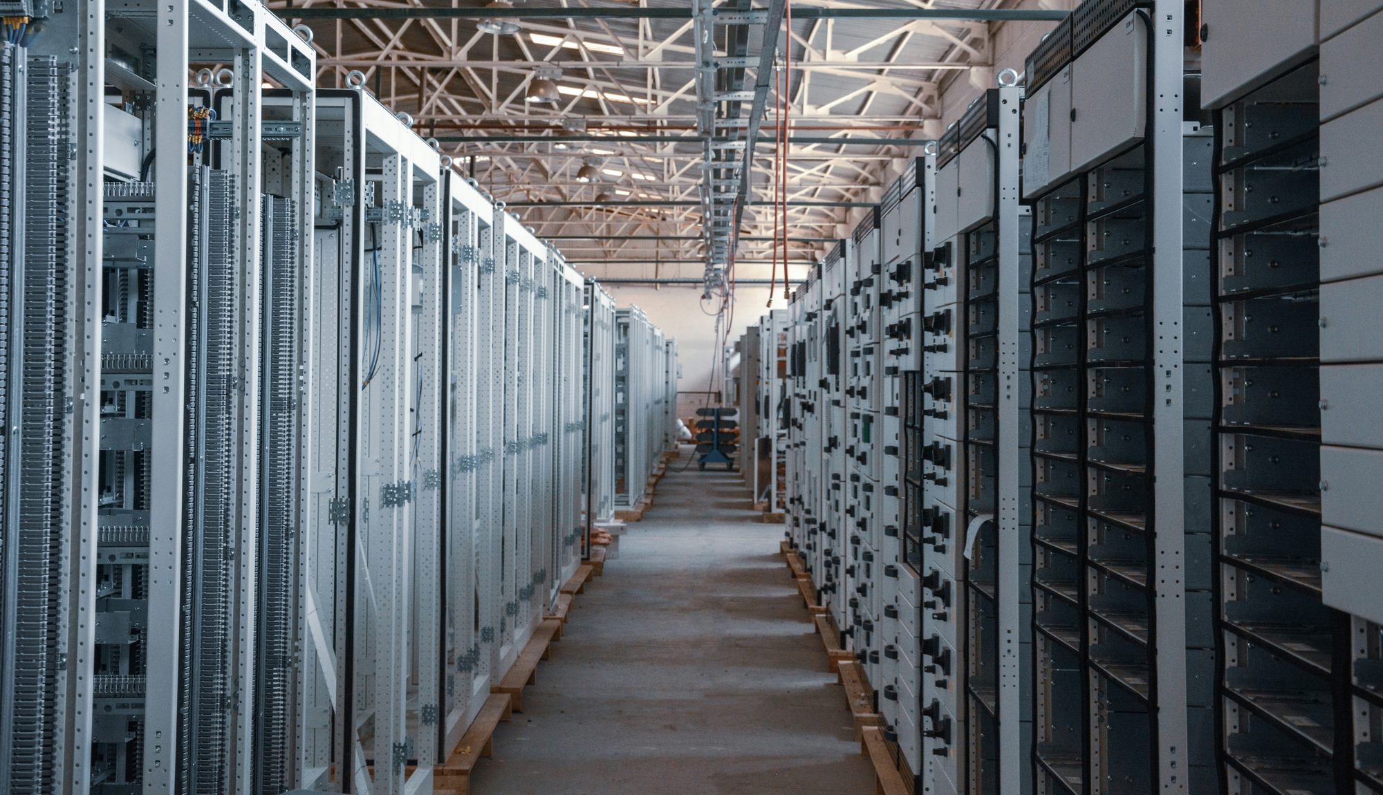 Rows of electrical switchgear cabinets in an assembly hall