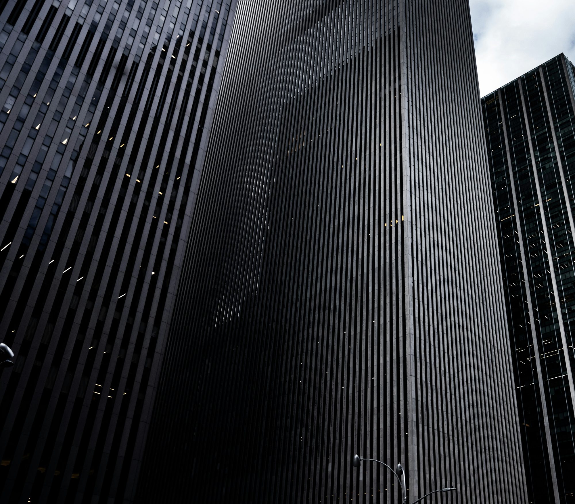Dark office towers seen from street level in Midtown Manhattan